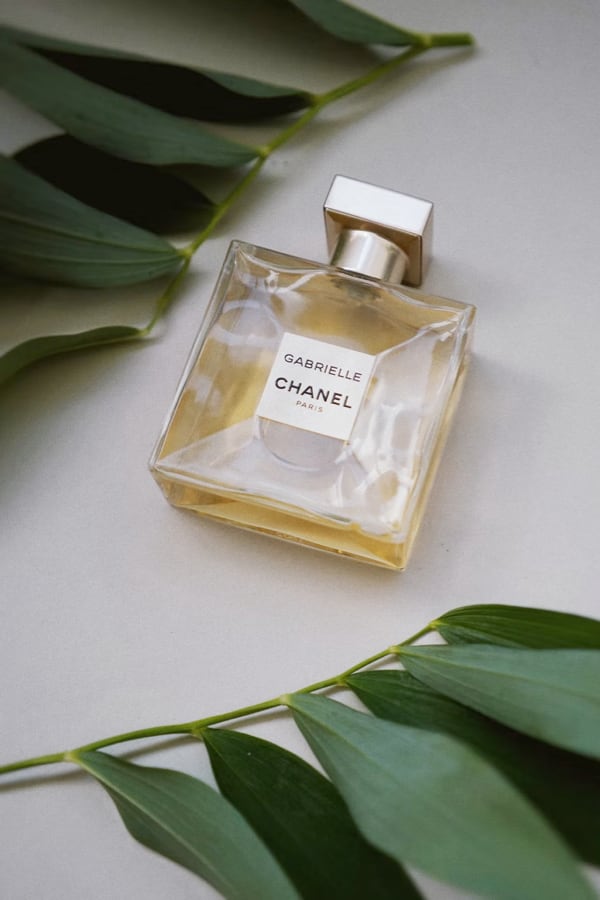 channel perfume bottle for women covered with leaves